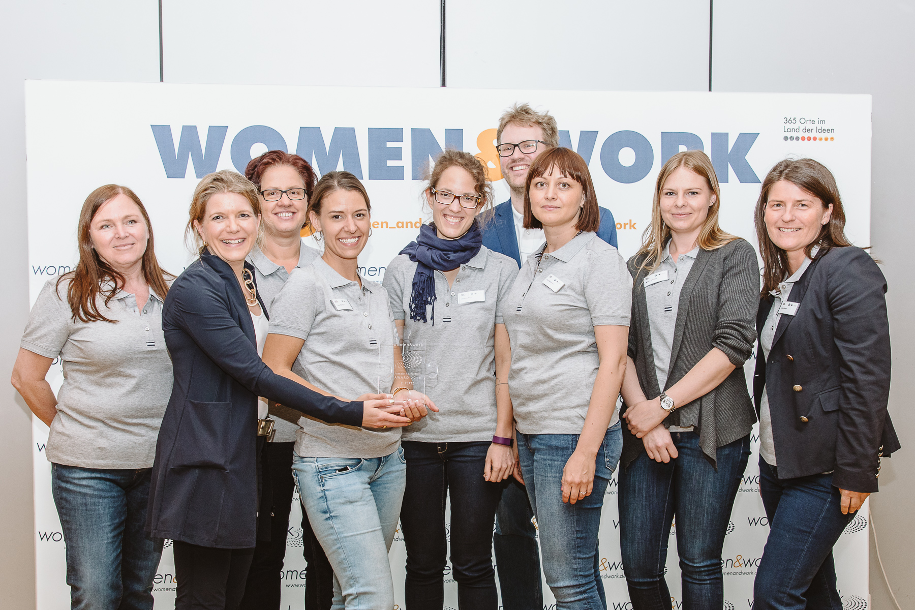 Kongressfotografie - women&work - Gruppenfoto eines Gewinnerteams mit Pokal